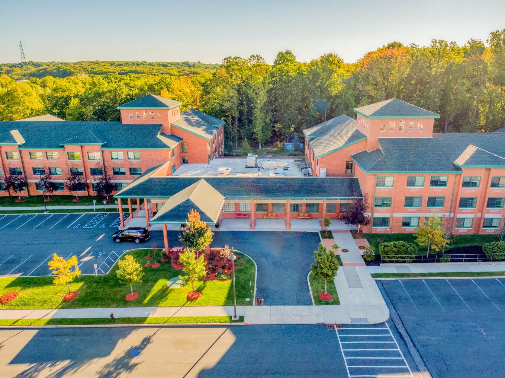 Aerial view of a senior living community with multiple units surrounded by trees and greenery.