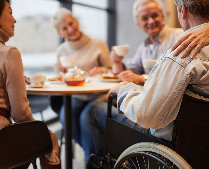 assisting senior in a wheelchair