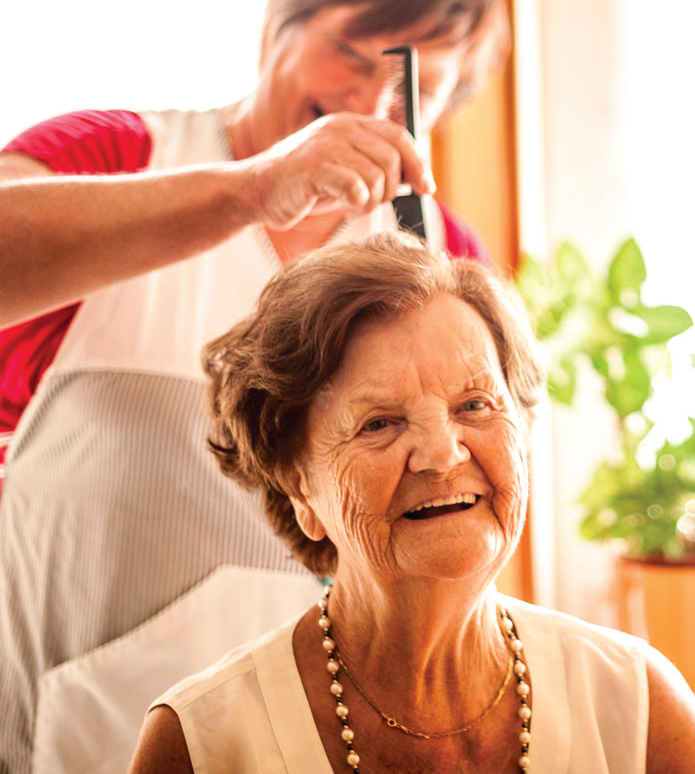 senior getting hair styled