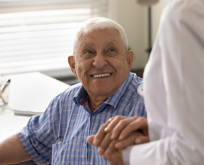 senior man grabbing nurses hand