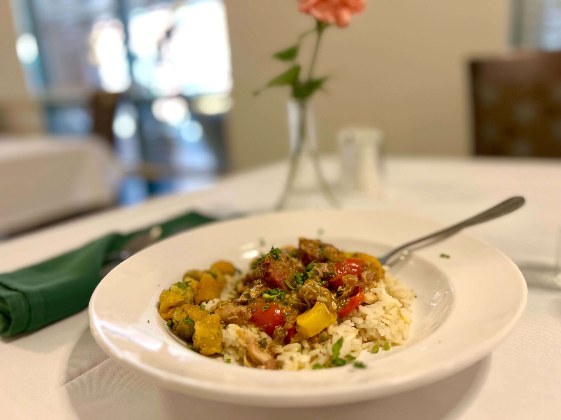 A dish of rice with vegetables and meat served at a senior living community dining area.