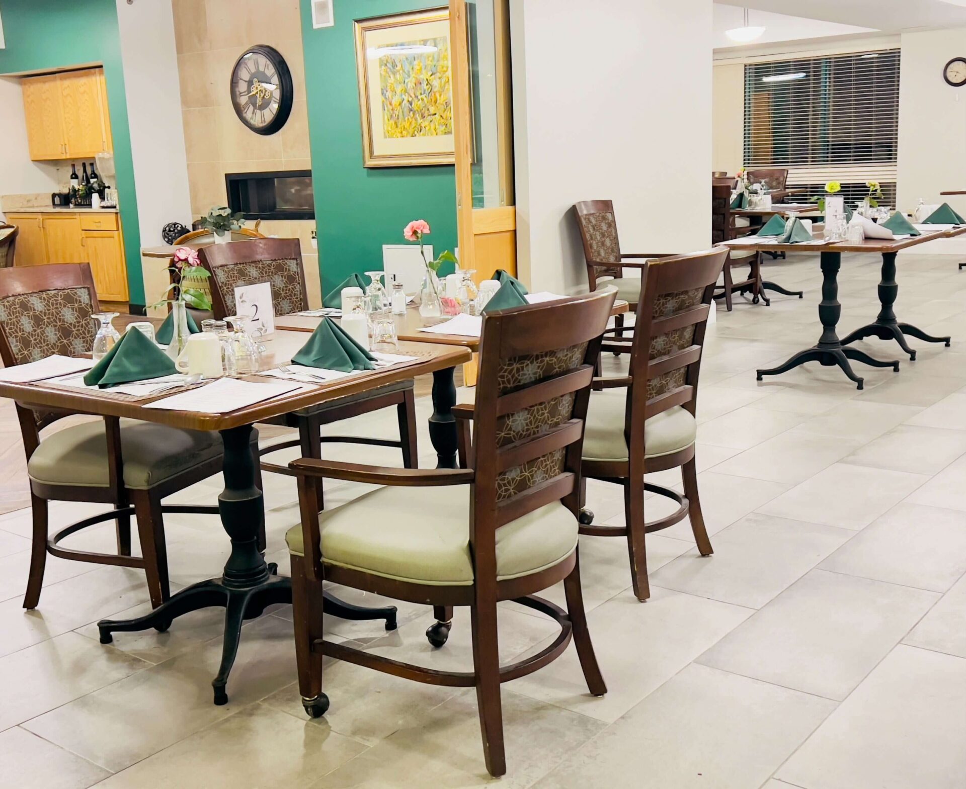 Dining area for senior living community with neatly arranged tables and chairs.