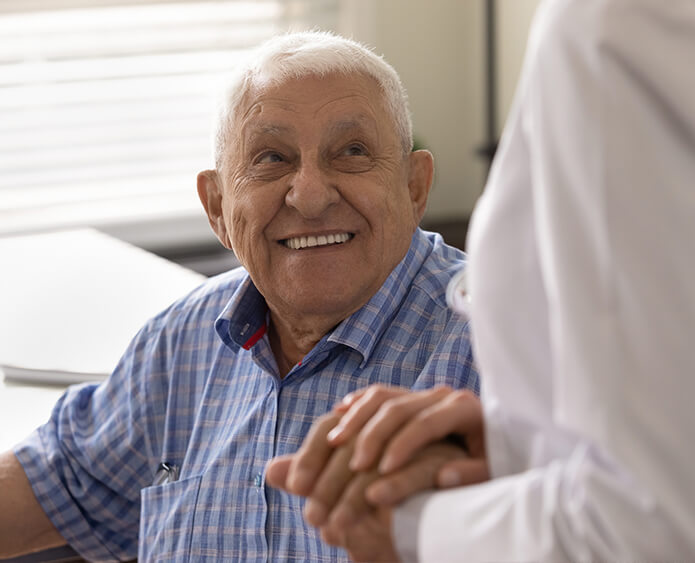 senior man holding doctors hand