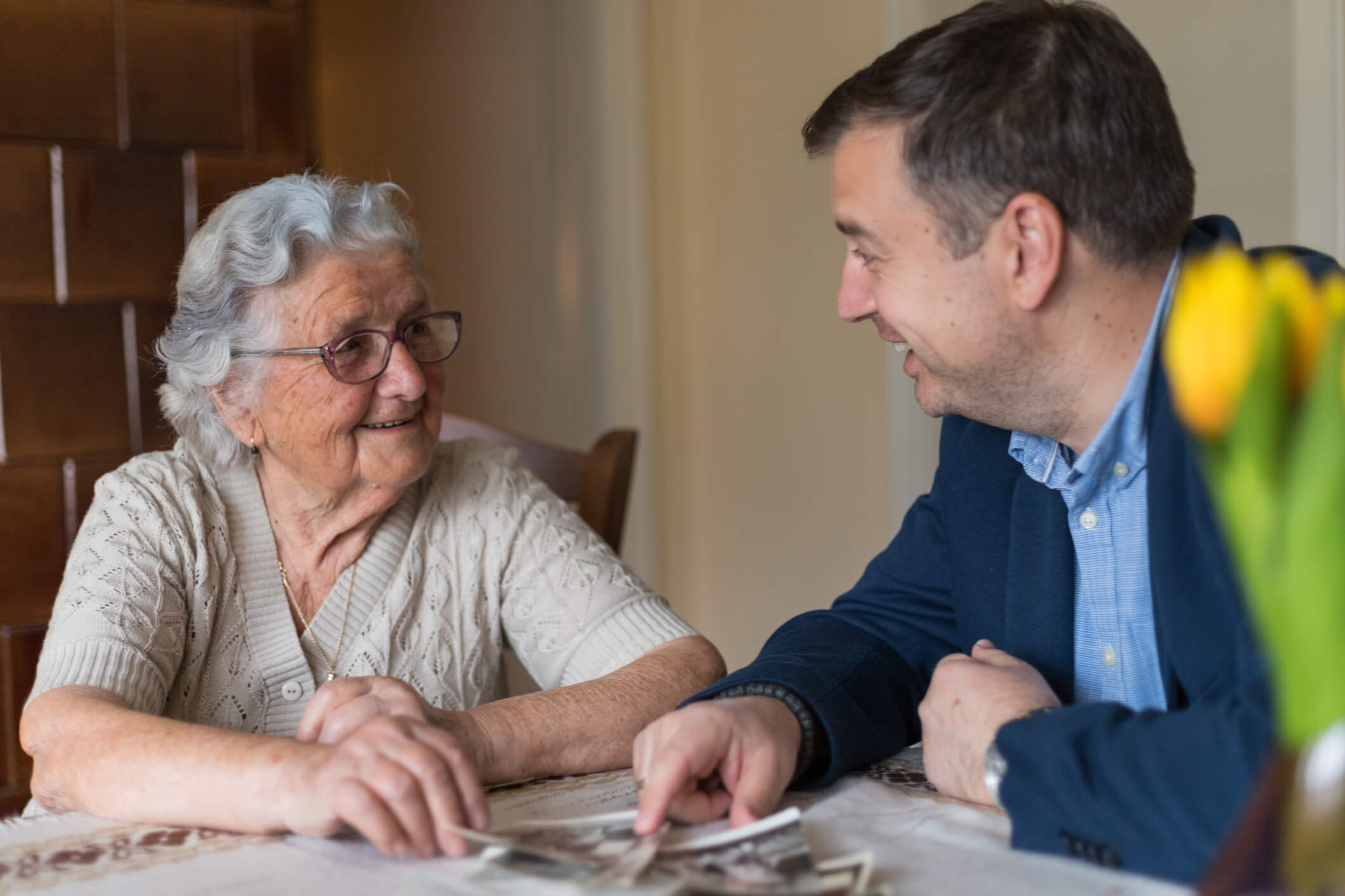 Senior woman and staff member having a friendly conversation in a unit at a senior community.