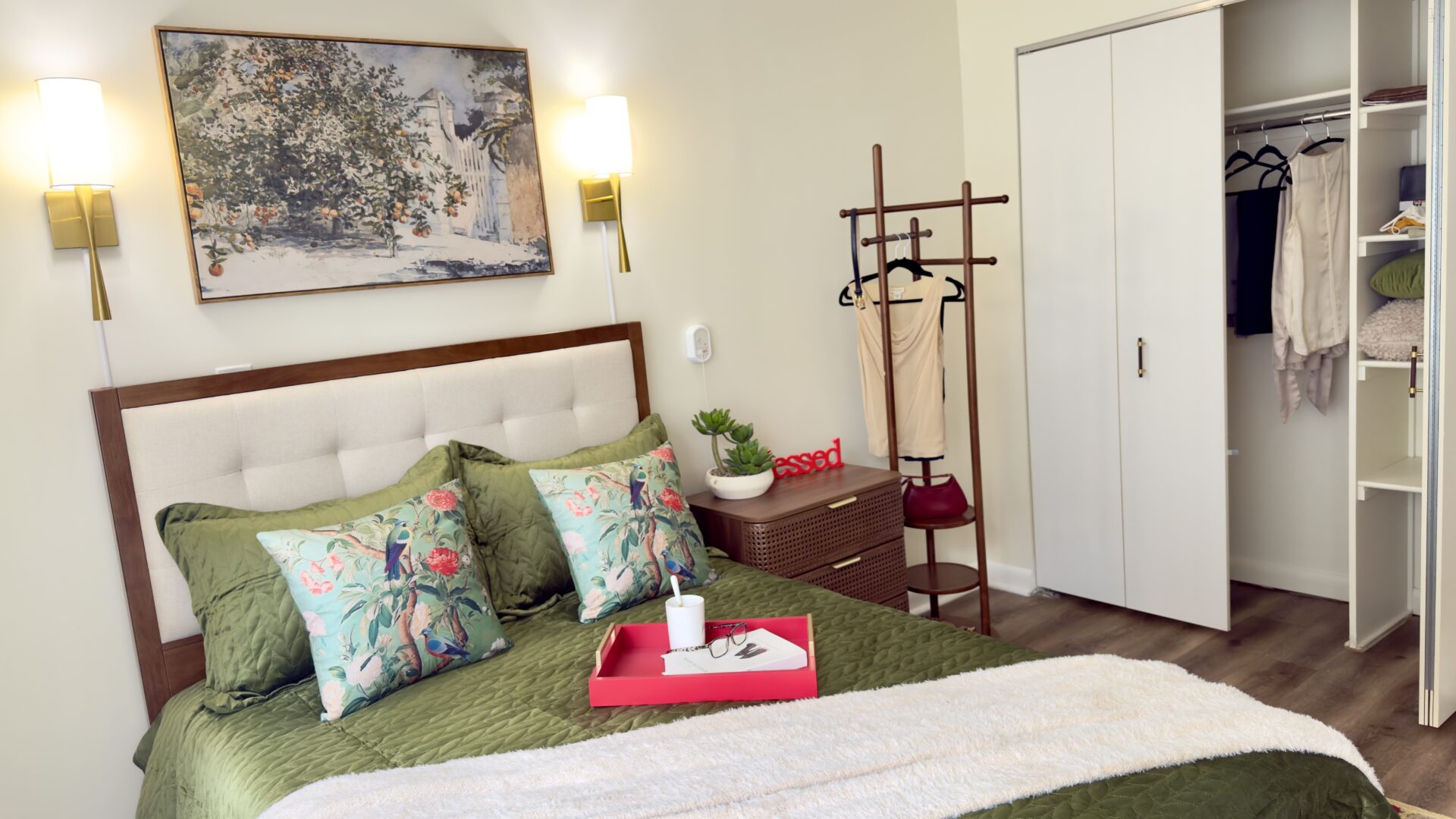 Image (3) decorated bedroom with large closet and made bed.