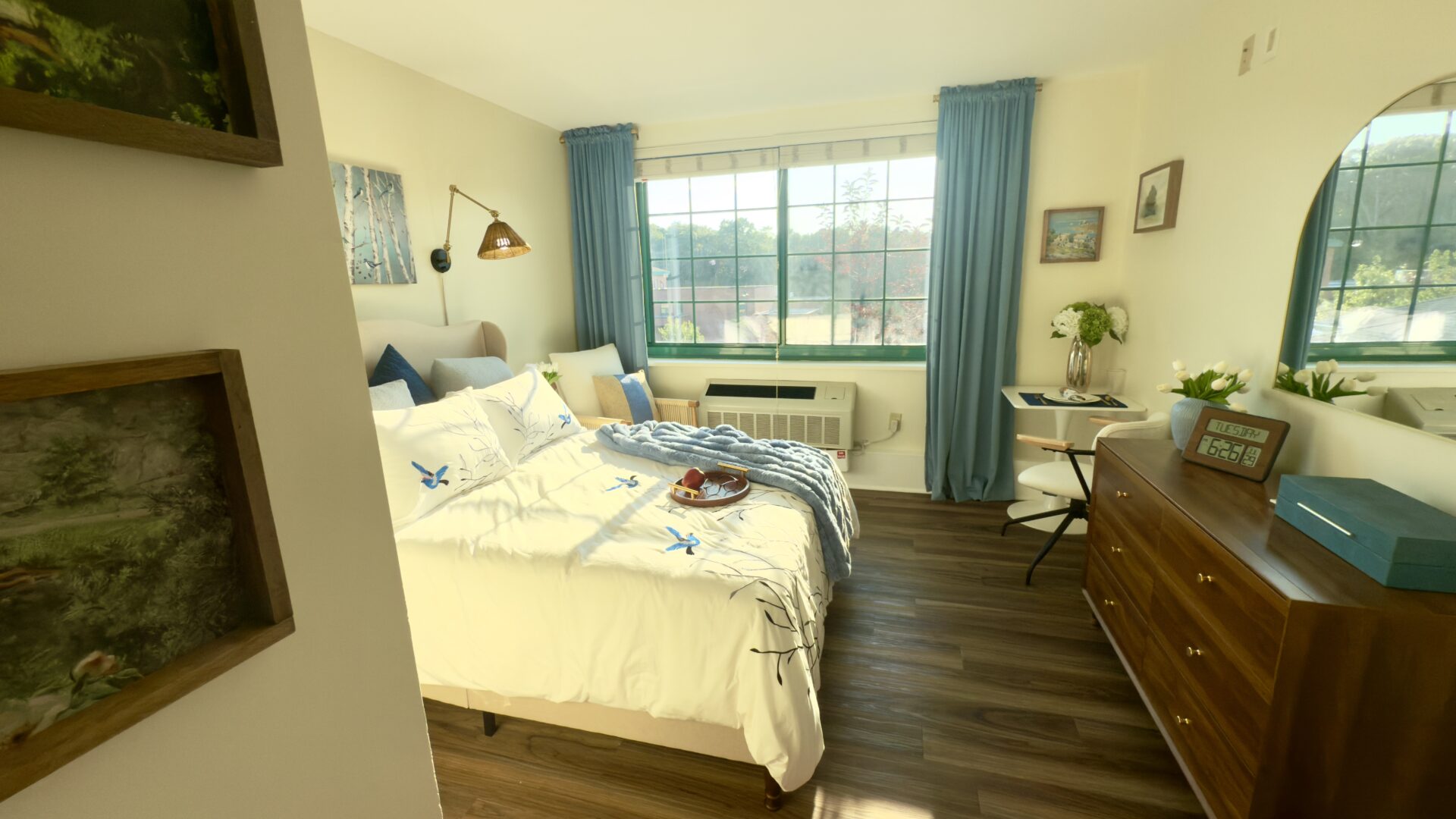 bright bedroom with large window with blue and white accents