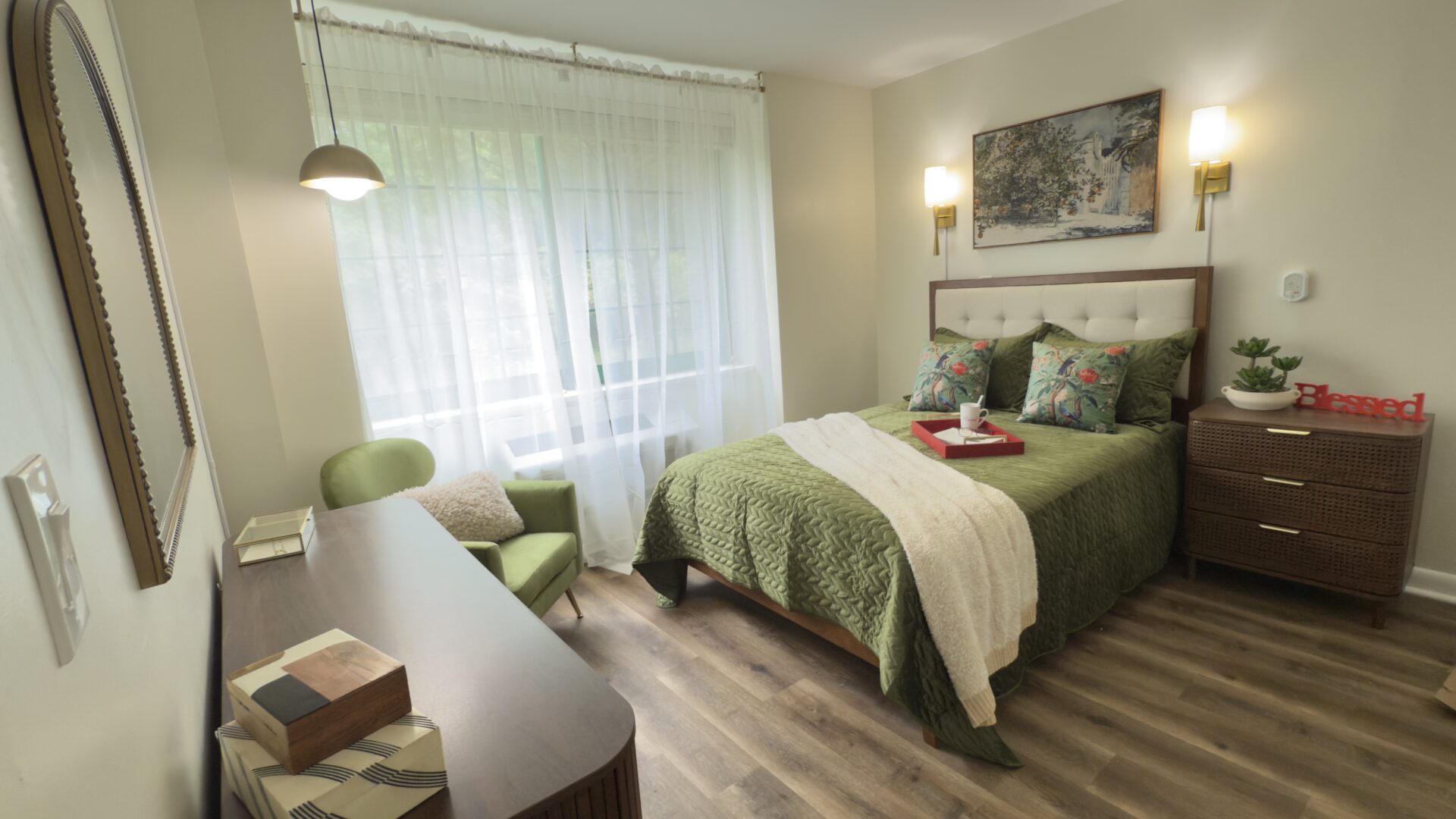 modern bed with green bedding along with matching bedroom furniture